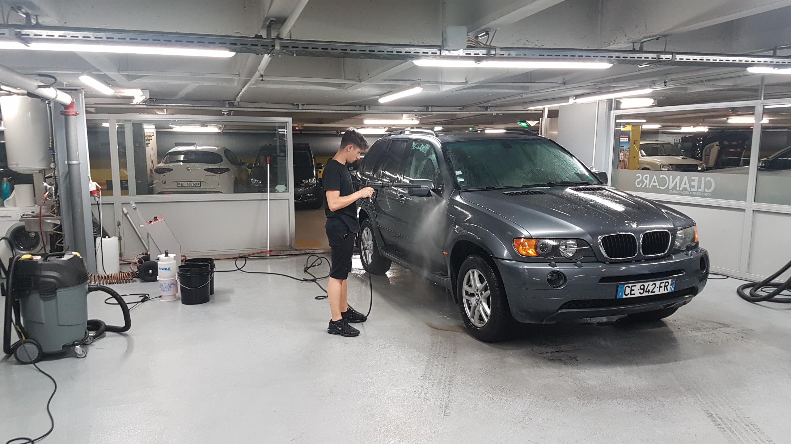 Manual washing of vehicle in parking garage underground garage